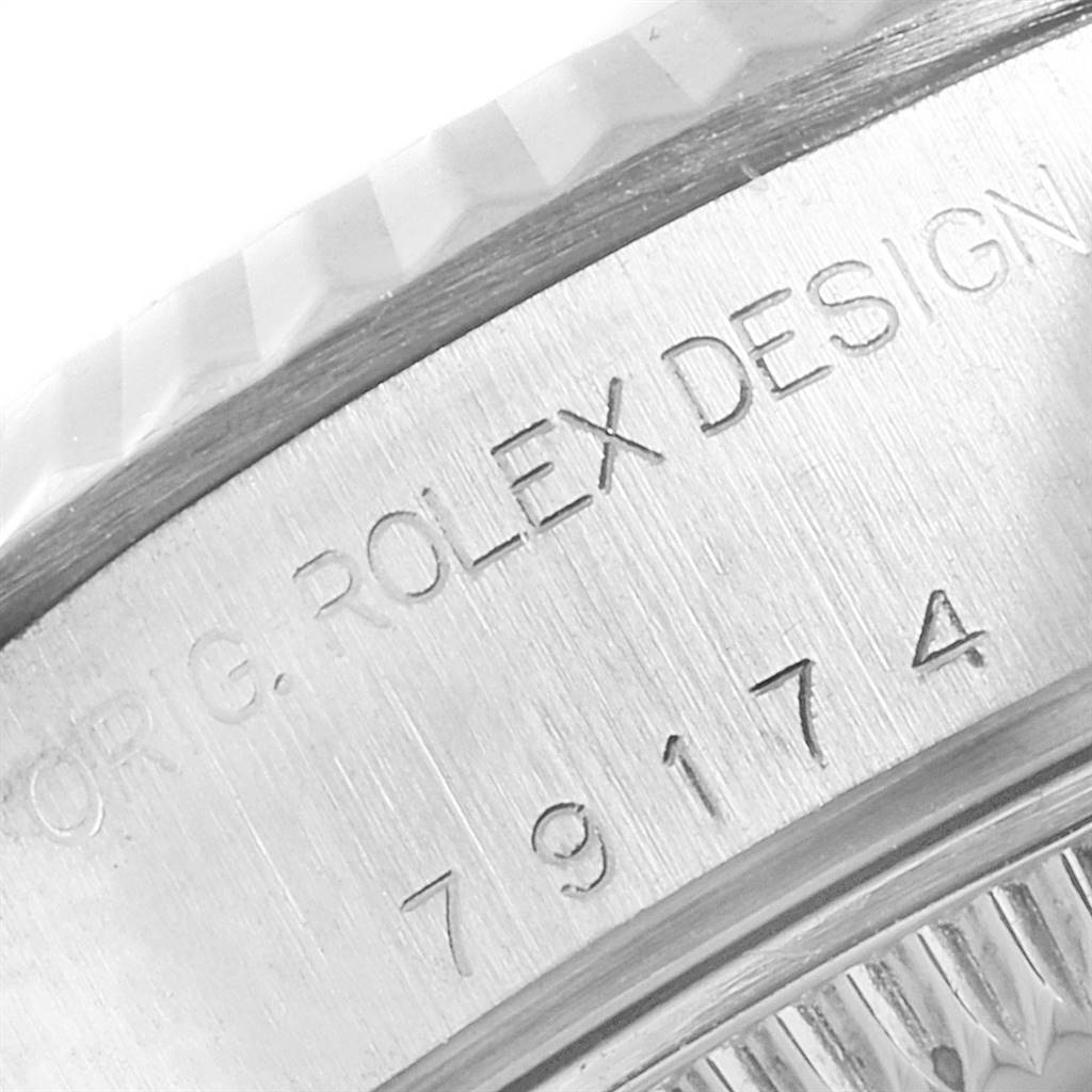 The image shows a close-up of the engraved side of the casing of a Rolex Datejust 79174 Women's Stainless Steel Silver Dial 79174 Women's Stainless Steel Silver Dial watch.