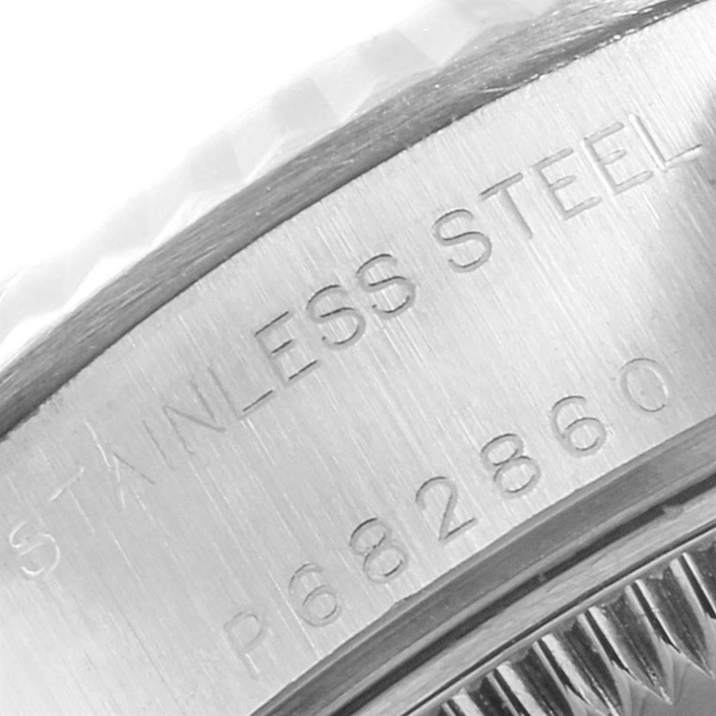 This image shows a close-up of the stainless steel engraving and part of the fluted bezel of the Rolex Datejust 79174 Women's Stainless Steel Silver Dial 79174 Women's Stainless Steel Silver Dial watch.