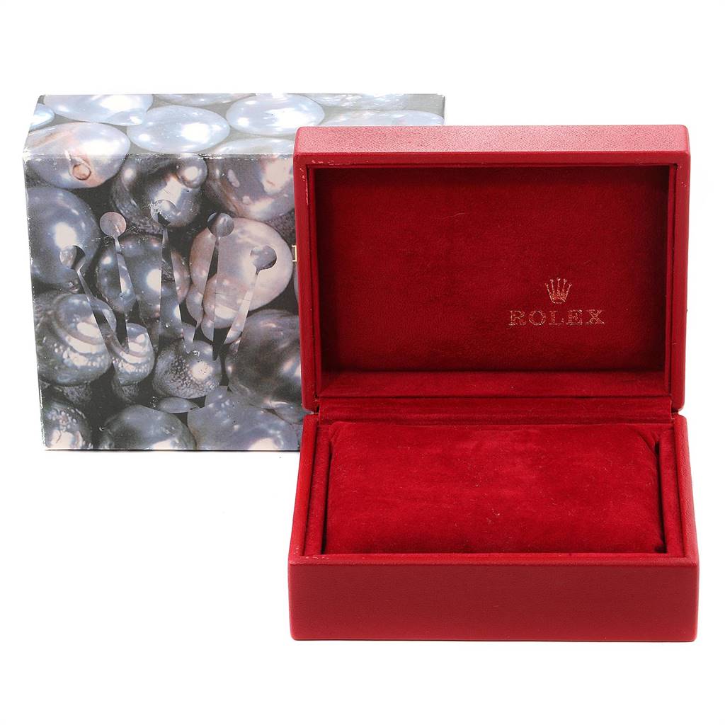 The image shows a red Rolex Datejust 79174 Women's Stainless Steel Silver Dial 79174 Women's Stainless Steel Silver Dial watch box, open to reveal the interior, with a decorative outer box in the background.