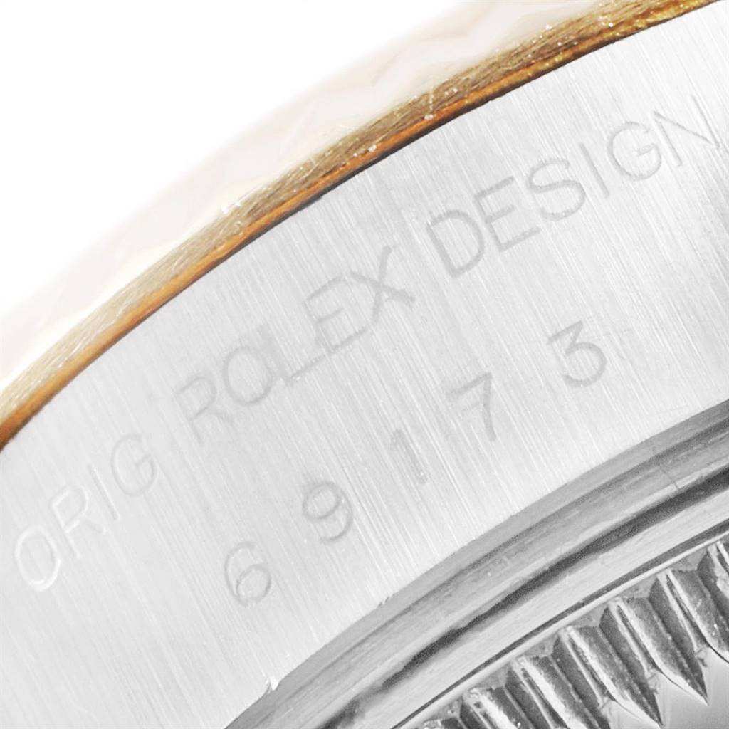 This image shows a close-up of the engraved bezel and serial number of a Rolex Datejust 69173 Women's Stainless Steel White Dial 69173 Women's Stainless Steel White Dial watch.
