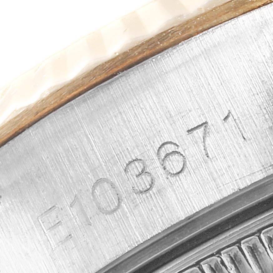 This close-up image focuses on the serial number engraved on the side of the case of a Rolex Datejust 79173 Women's Stainless Steel Black Dial 79173 Women's Stainless Steel Black Dial watch.