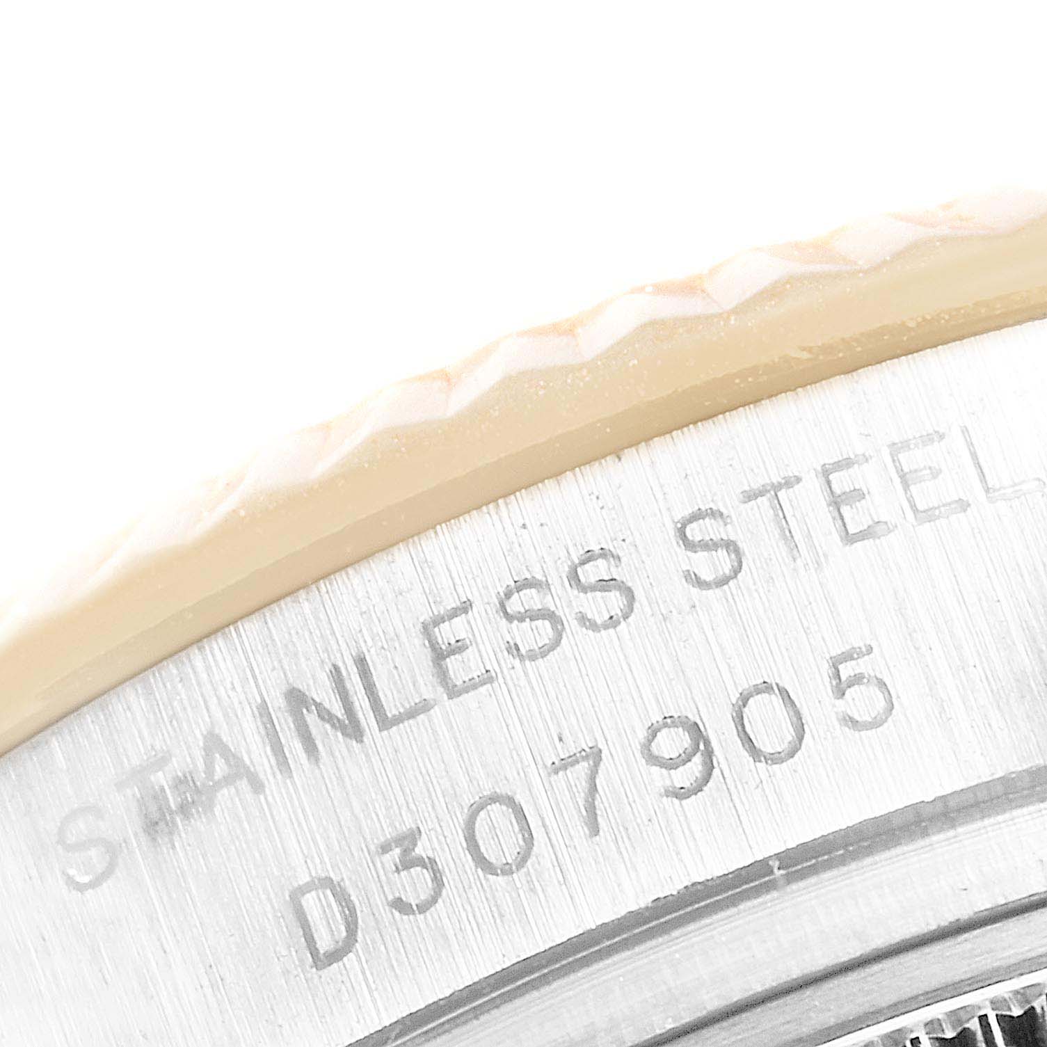 This close-up angle shows the engraved serial number and part of the bezel of a Rolex Datejust 179173 Women's Steel and Gold (two tone) White Dial 179173 Women's Steel and Gold (two tone) White Dial watch.