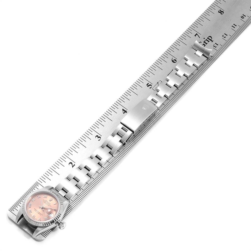 The image shows a Rolex Datejust 79174 Women's Stainless Steel Pink Dial 79174 Women's Stainless Steel Pink Dial watch from the top angle, partially measured against a ruler, highlighting the case, dial, and bracelet.