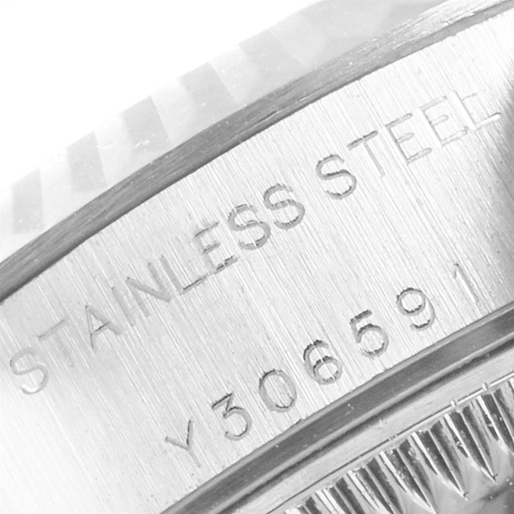 The image shows a close-up of the serial number and stainless steel text on the side of the bezel of a Rolex Datejust 79174 Women's Stainless Steel Pink Dial 79174 Women's Stainless Steel Pink Dial watch.