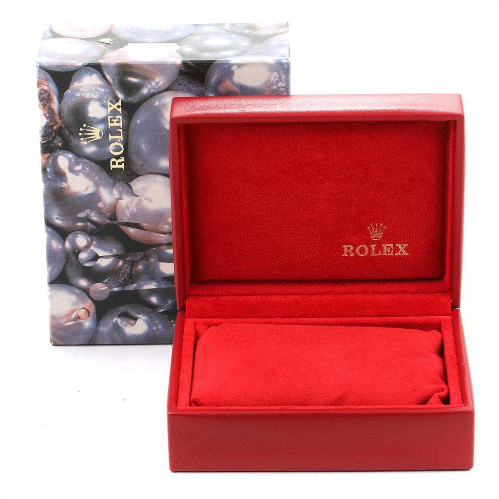 The image shows a red Rolex watch box with a "Rolex" logo, and an outer box with a pearlescent design.