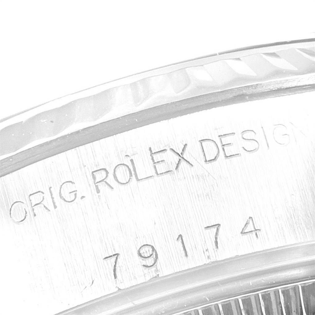 The image shows a close-up of the engraving on the case of a Rolex Datejust 79174 Women
s Stainless Steel Mother of Pearl Dial 79174 Women
s Stainless Steel Mother of Pearl Dial watch.