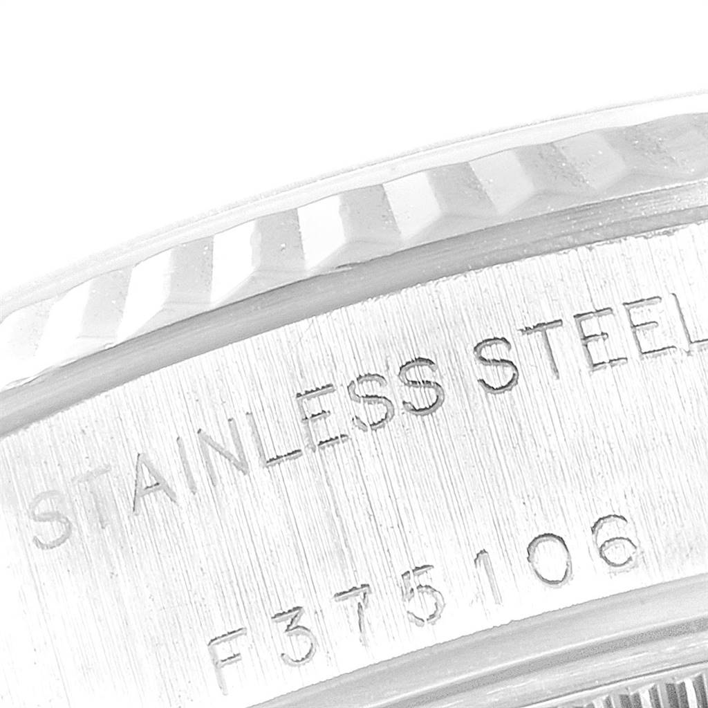 This image shows a close-up of the side of the bezel and case of a Rolex Datejust 79174 Women
s Stainless Steel Mother of Pearl Dial 79174 Women
s Stainless Steel Mother of Pearl Dial watch, highlighting the "STAINLESS STEEL" engraving.