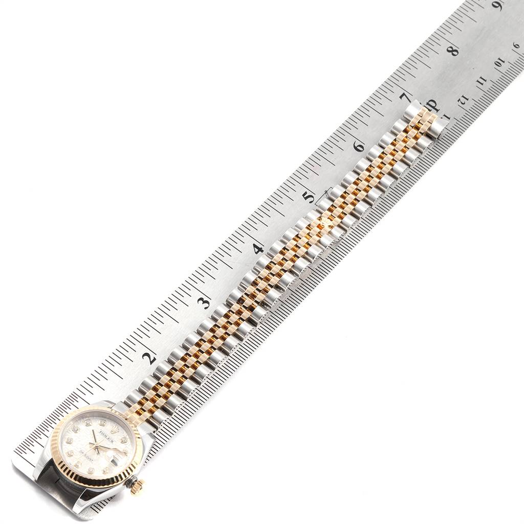 The image shows a top-down view of a Rolex Datejust 179173 Women's Steel and Gold (two tone) Silver Dial 179173 Women's Steel and Gold (two tone) Silver Dial watch, emphasizing the bracelet alongside a ruler for measurement.