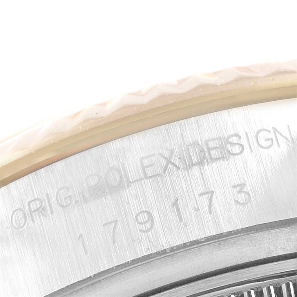 This is a close-up view of the case edge and bezel of a Rolex Datejust 179173 Women's Steel and Gold (two tone) Silver Dial 179173 Women's Steel and Gold (two tone) Silver Dial watch, showing part of the model number and "ROLEX DESIGN" engraving.