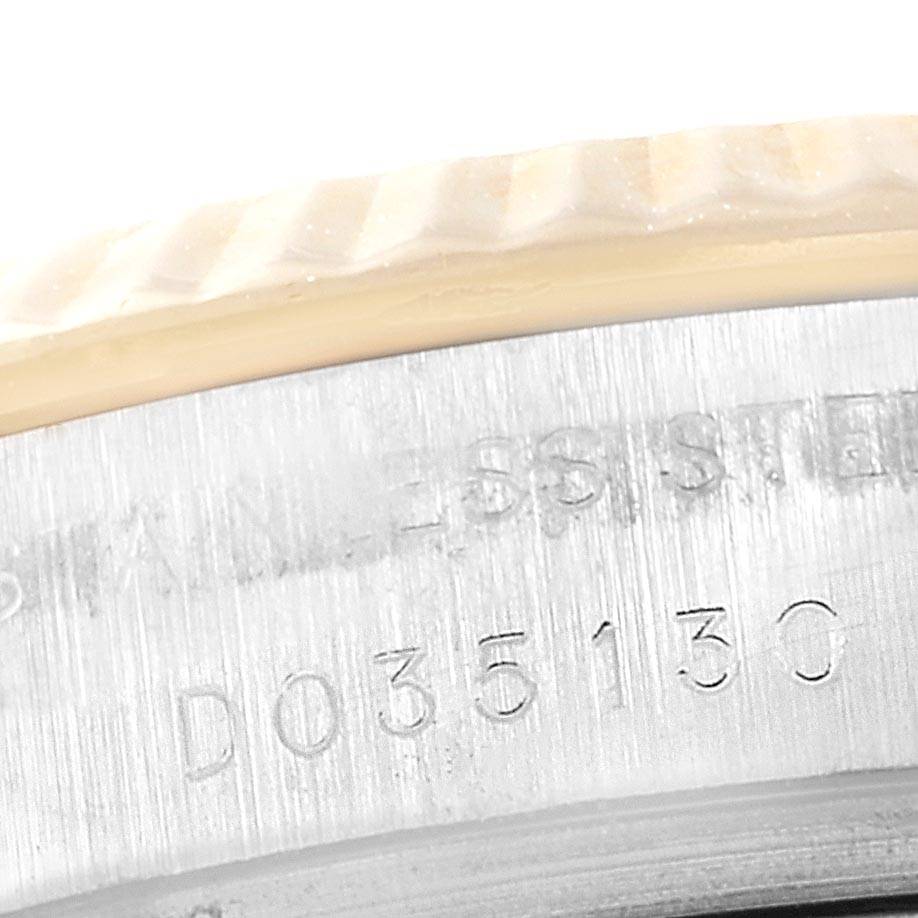 This close-up image shows the serial number and the fluted bezel of a Rolex Datejust 179173 Women's Steel and Gold (two tone) Silver Dial 179173 Women's Steel and Gold (two tone) Silver Dial watch.