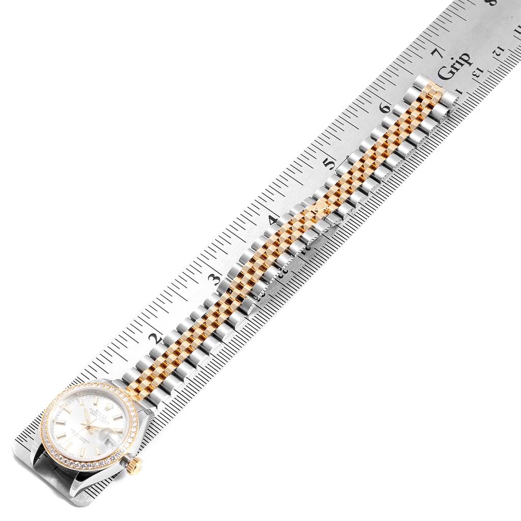 This image shows the Rolex Datejust 279383 Women's Steel and Gold (two tone) Silver Dial 279383 Women's Steel and Gold (two tone) Silver Dial watch laid flat next to a ruler, displaying its face and two-tone bracelet.