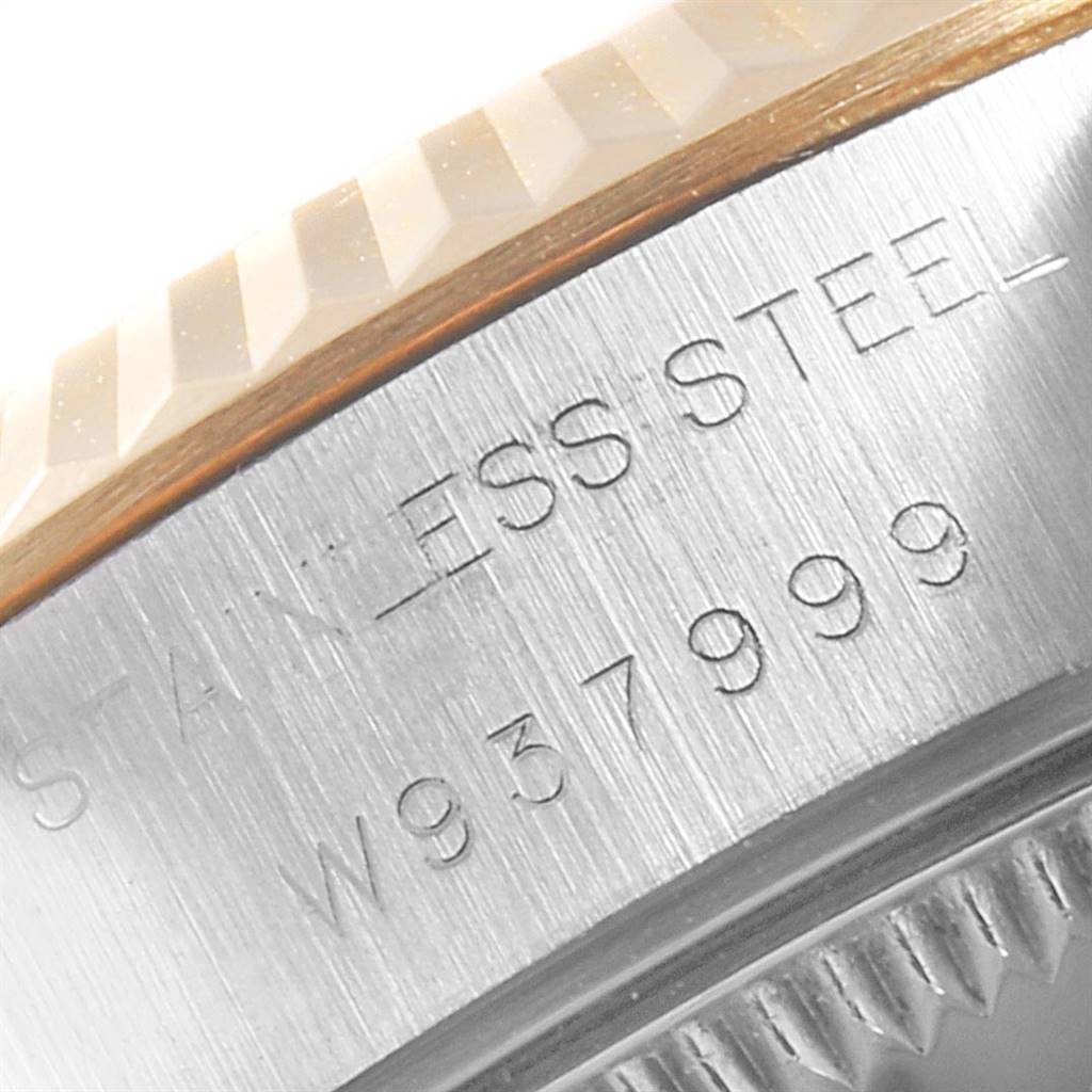 The image shows a close-up of the stainless steel case and part of the fluted bezel of a Rolex Datejust 69173 Women's Steel and Gold (two tone) Black Dial 69173 Women's Steel and Gold (two tone) Black Dial.