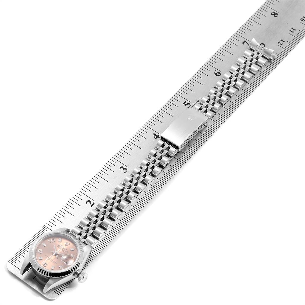 The image shows a Rolex Datejust 79174 Women's Stainless Steel Pink Dial 79174 Women's Stainless Steel Pink Dial watch aligned with a ruler, with the dial, bracelet, and clasp visible from a top view.