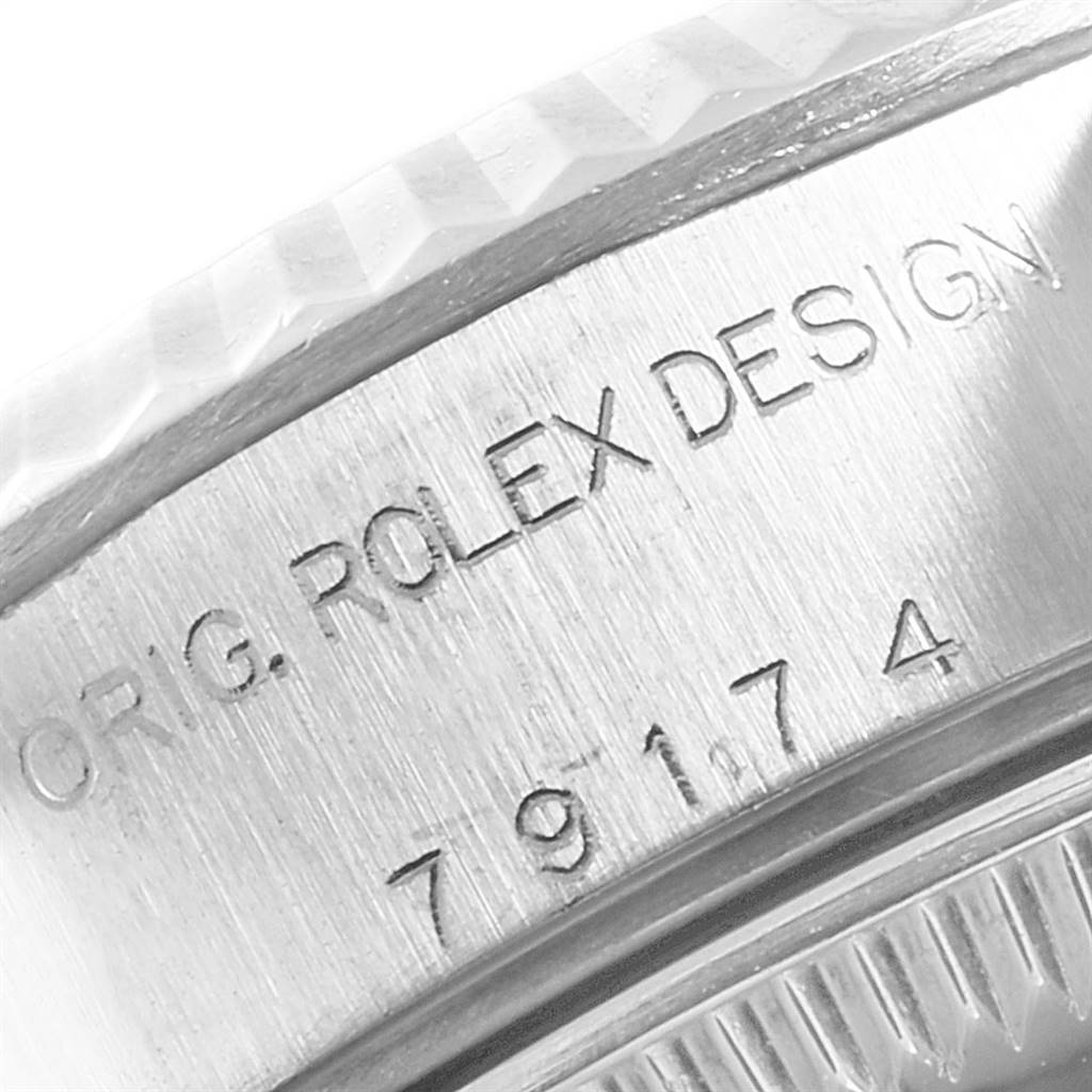 This image shows a close-up of the case side of a Rolex Datejust 79174 Women's Stainless Steel Pink Dial 79174 Women's Stainless Steel Pink Dial watch, highlighting the engraved model number and design.