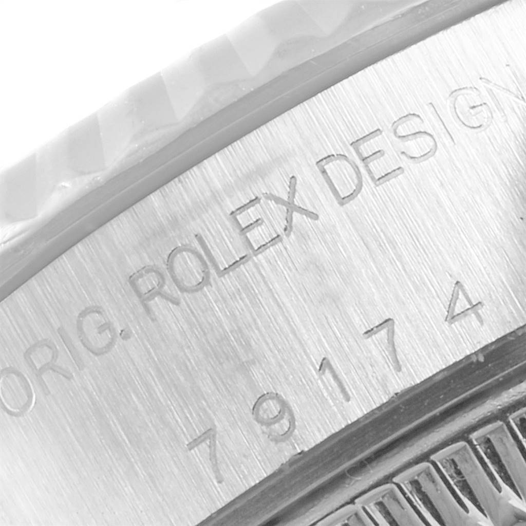 The image shows a close-up view of the inscription on the case back of a Rolex Datejust 79174 Women's Stainless Steel Blue Dial 79174 Women's Stainless Steel Blue Dial watch.