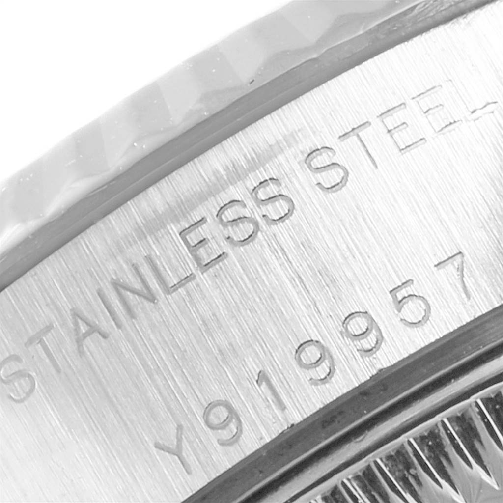 This image shows a close-up of the engraved serial number and "STAINLESS STEEL" on a Rolex Datejust 79174 Women's Stainless Steel Blue Dial 79174 Women's Stainless Steel Blue Dial model watch.