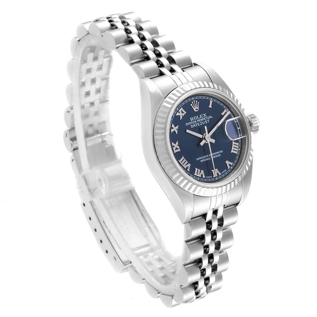 A Rolex Datejust 79174 Women's Stainless Steel Blue Dial 79174 Women's Stainless Steel Blue Dial watch is shown at a three-quarter angle, highlighting its blue dial, fluted bezel, and jubilee bracelet.