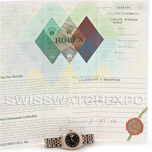 The image shows a Rolex Datejust 179171 Women's Steel and Gold (two tone) Black Dial 179171 Women's Steel and Gold (two tone) Black Dial model watch placed with its paperwork and warranty documents in the background.