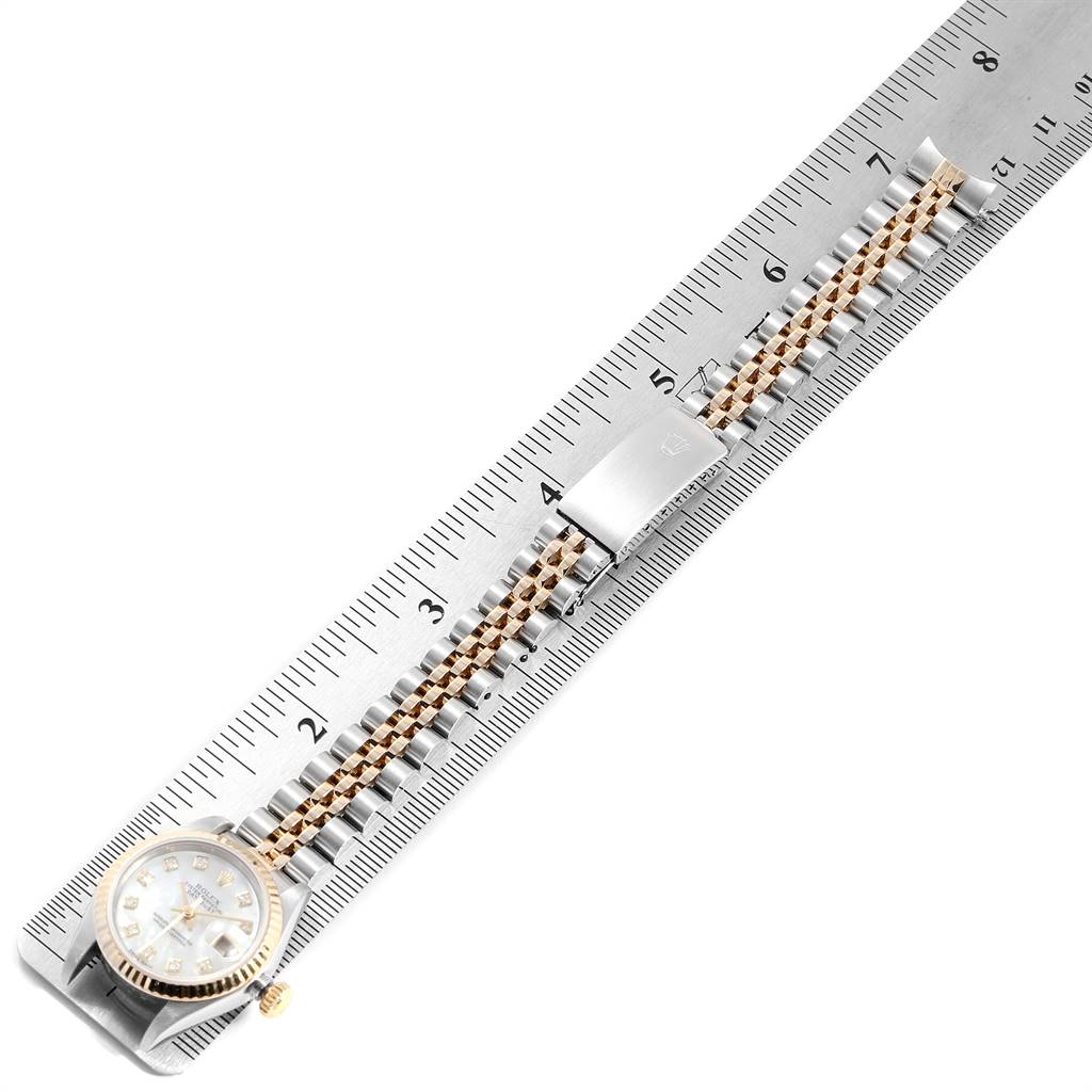 The image shows a Rolex Datejust 79173 Women's Stainless Steel Mother of Pearl Dial 79173 Women's Stainless Steel Mother of Pearl Dial watch and its bracelet laid flat on a measuring ruler, viewed from above.