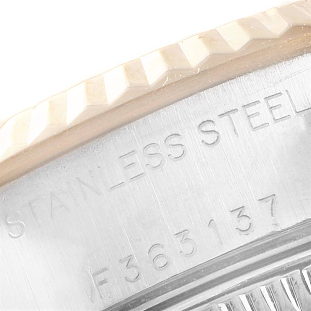 This close-up shows the fluted bezel and part of the engraved stainless steel case back of a Rolex Datejust 79173 Women's Stainless Steel Mother of Pearl Dial 79173 Women's Stainless Steel Mother of Pearl Dial watch.