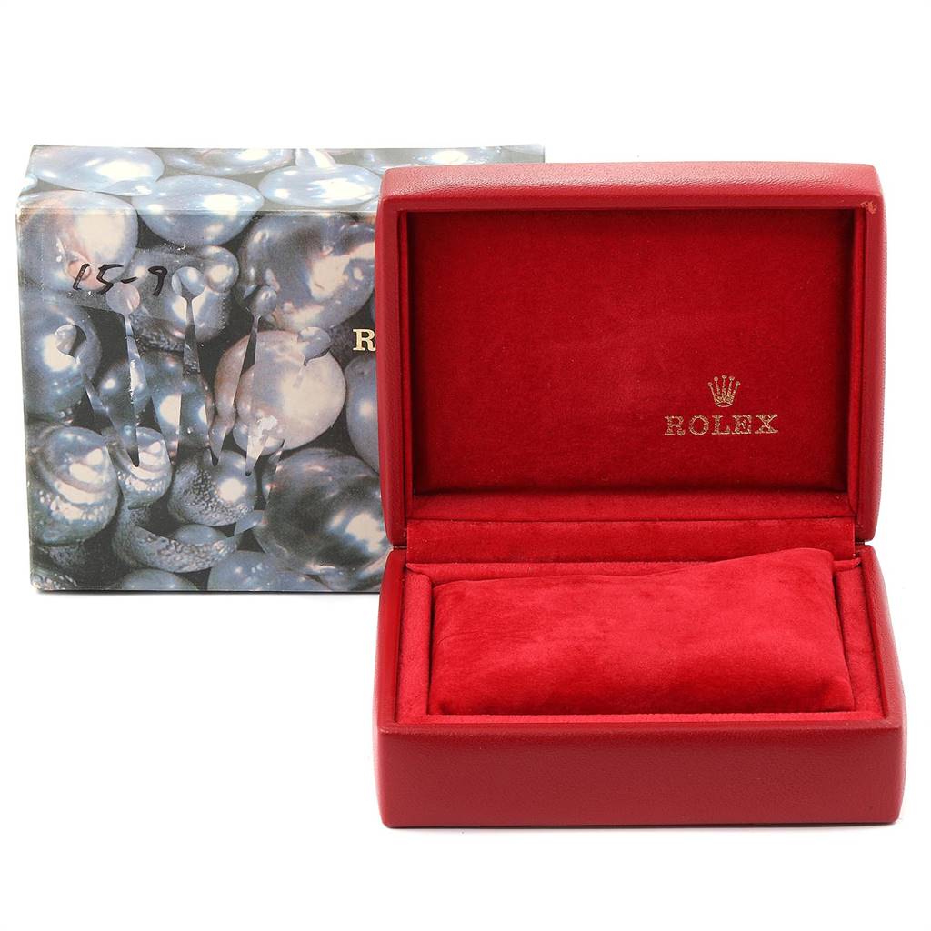 The image shows an open Rolex Datejust 79173 Women's Stainless Steel Mother of Pearl Dial 79173 Women's Stainless Steel Mother of Pearl Dial red watch box with the logo and a padded interior, placed in front of a decorative outer box.