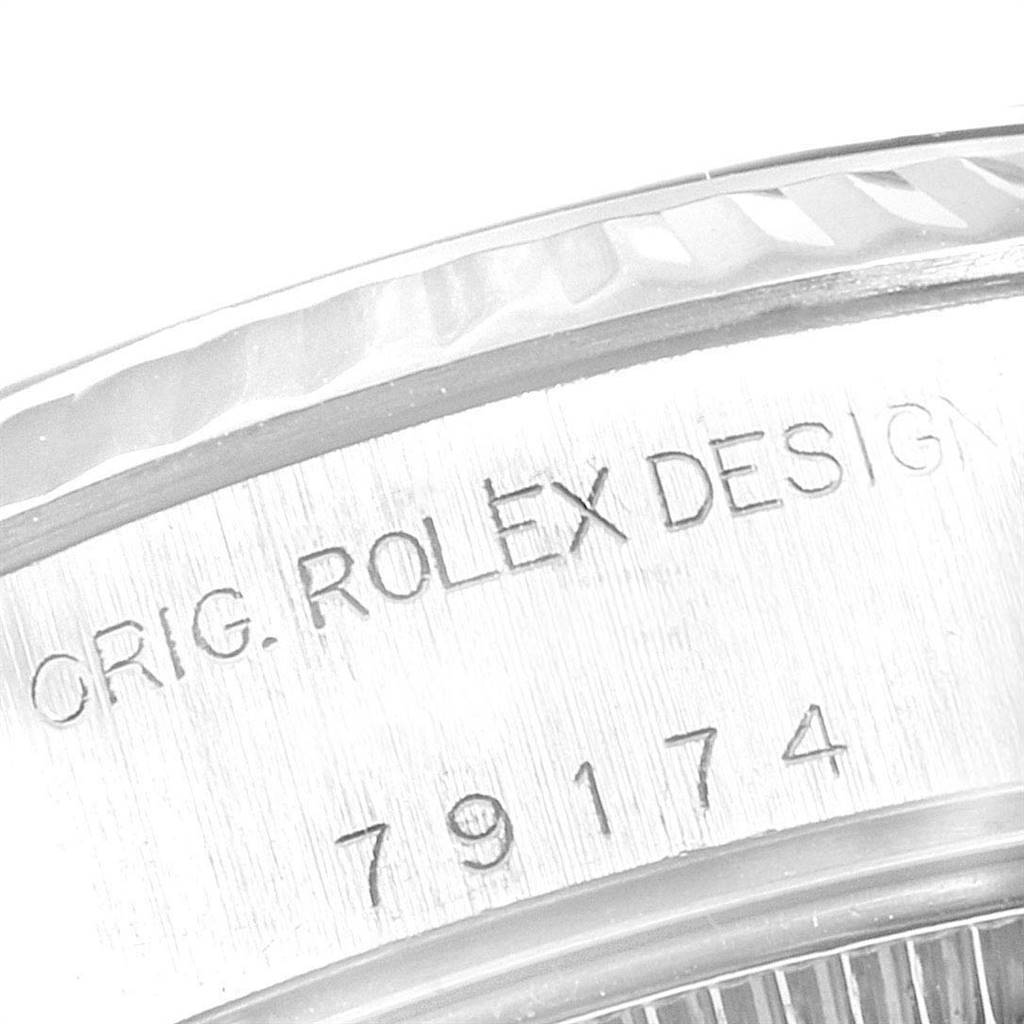 The image shows a close-up of the bezel and serial number on a Rolex Datejust 79174 Women
s Stainless Steel Mother of Pearl Dial 79174 Women
s Stainless Steel Mother of Pearl Dial watch.