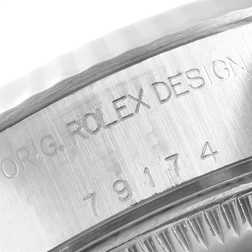 The image shows a close-up of the Rolex engraving and serial number on the side of a Datejust model watch case.