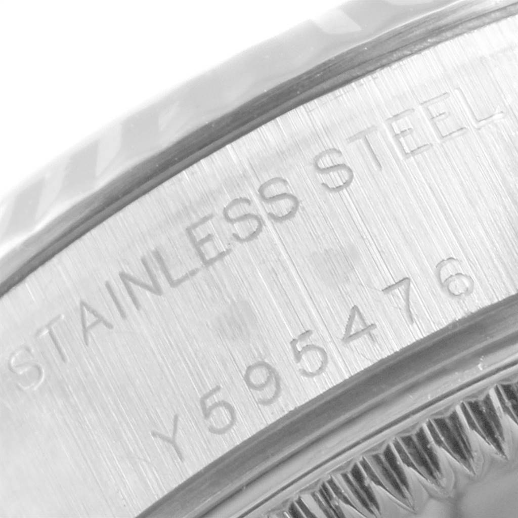 The image shows a close-up of the side of a Rolex Datejust 79174 Women
s Stainless Steel Silver Dial 79174 Women
s Stainless Steel Silver Dial watch, focusing on the stainless steel inscription and part of the bezel.
