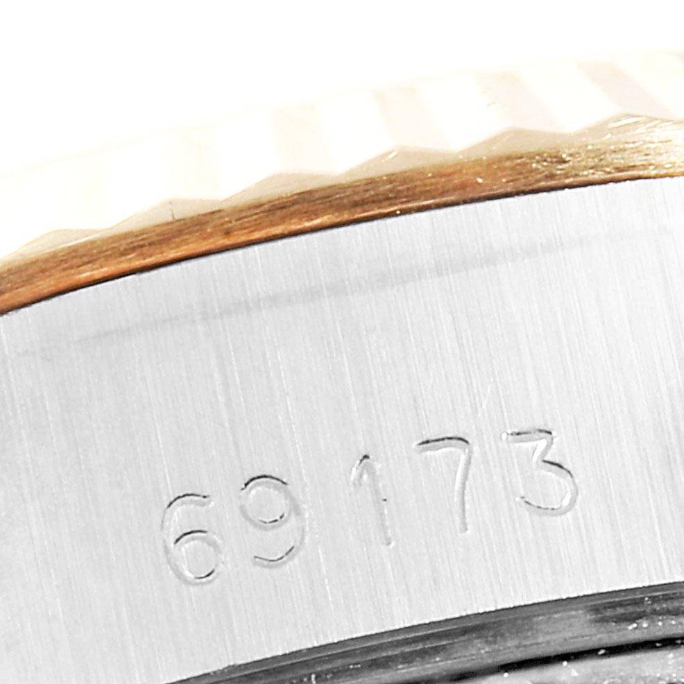 This close-up angle shows the model number "69173" etched on the side of a Rolex Datejust 69173 Women's Stainless Steel Champagne Dial 69173 Women's Stainless Steel Champagne Dial watch bezel.