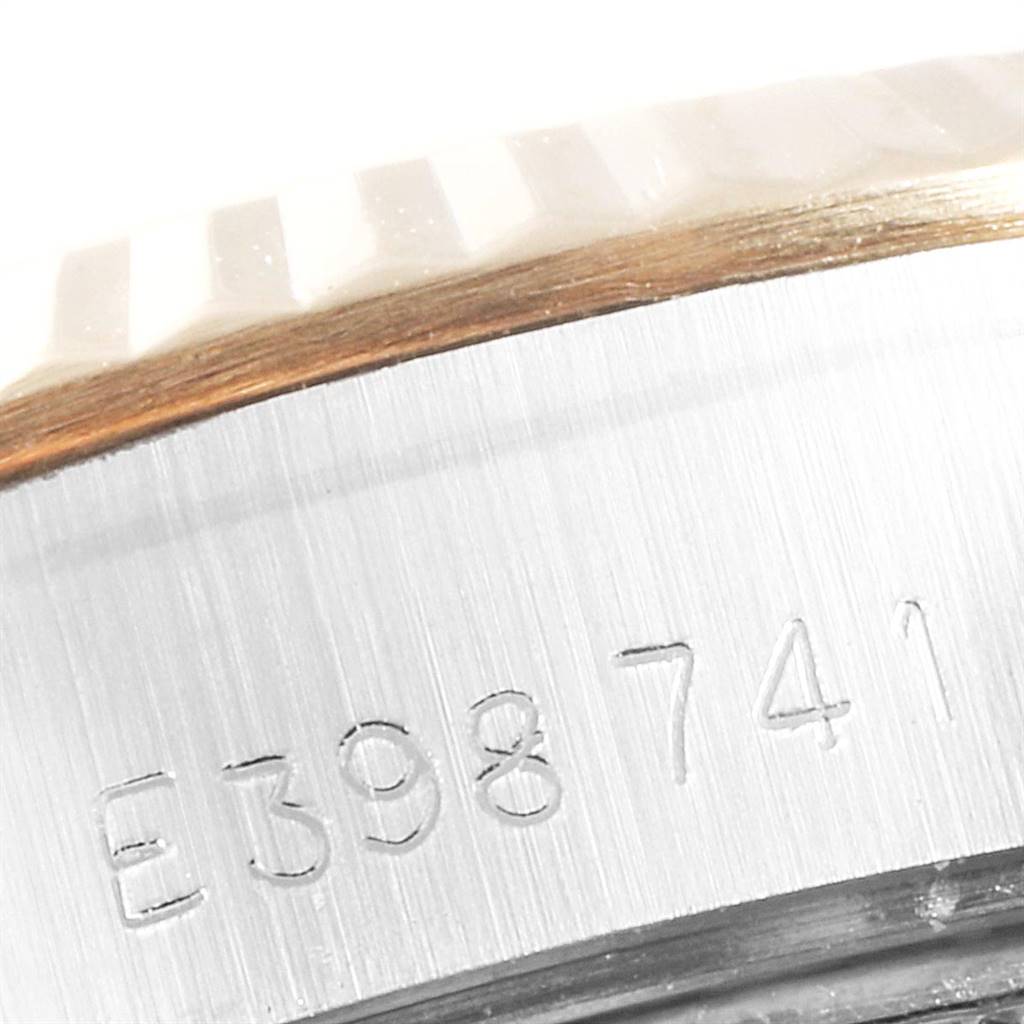 This close-up image shows the Rolex Datejust 69173 Women's Stainless Steel Champagne Dial 69173 Women's Stainless Steel Champagne Dial's side view, highlighting the serial number engraving and part of the bezel.