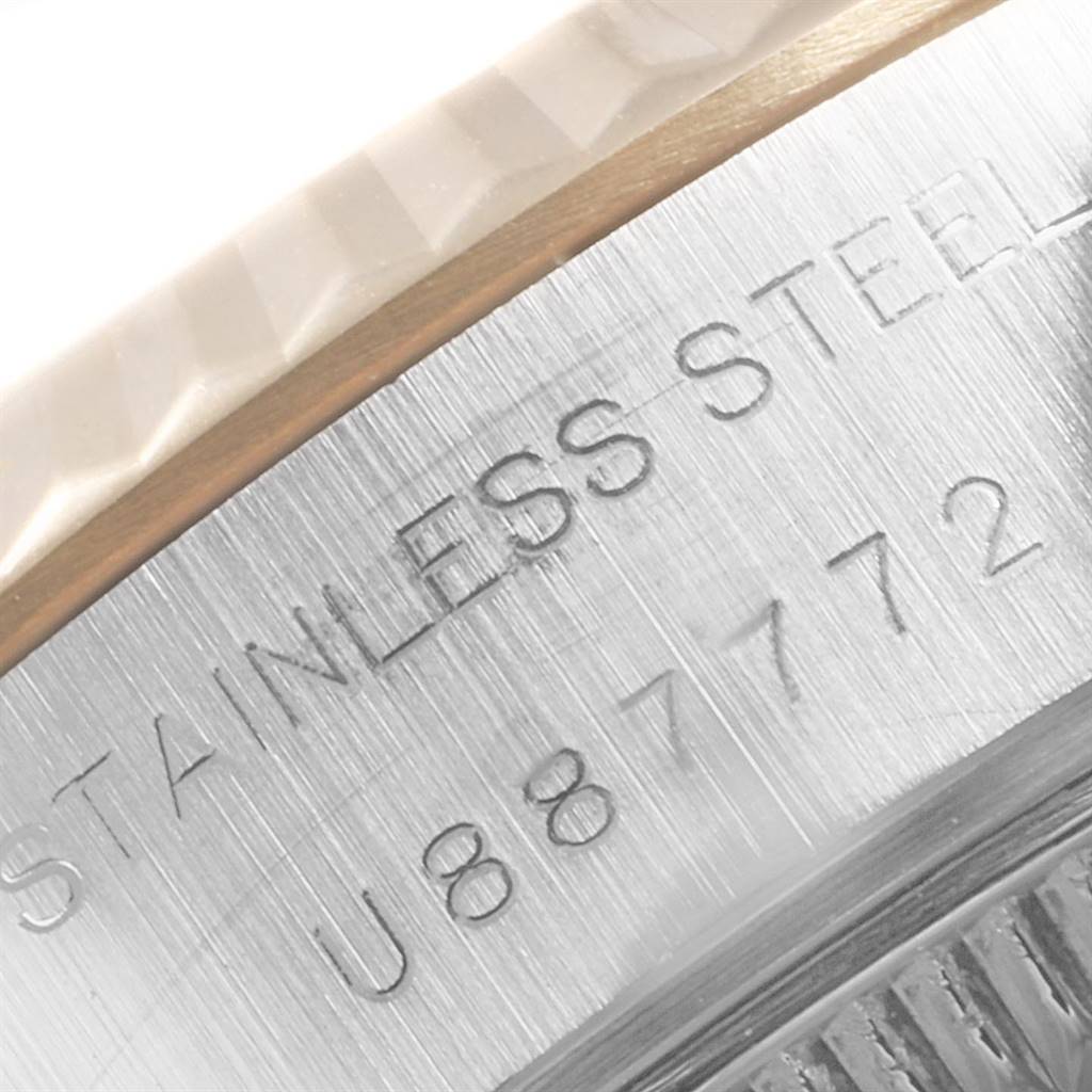 The image shows a close-up of the engraved serial number and "STAINLESS STEEL" text on the bezel of a Rolex Datejust 69173 Women's Stainless Steel Champagne Dial 69173 Women's Stainless Steel Champagne Dial watch.
