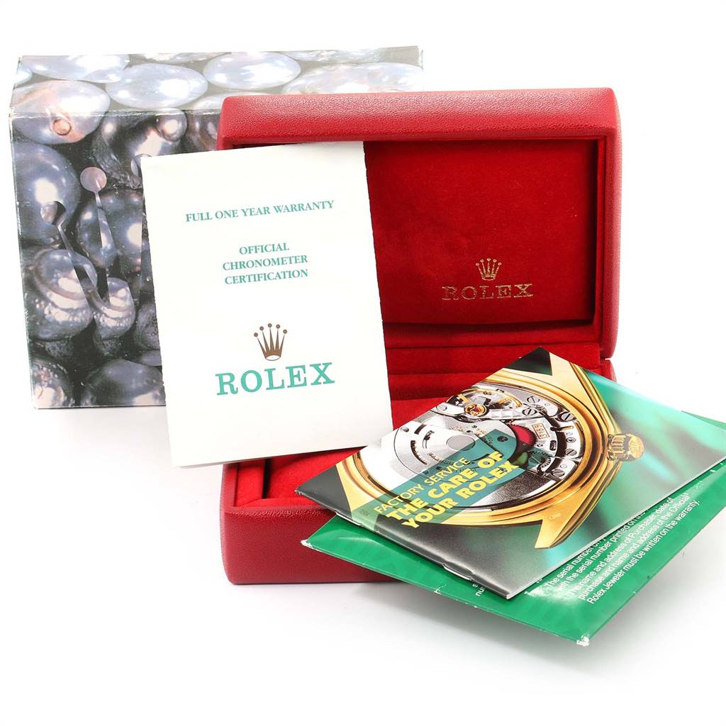 The image shows a red Rolex box with official papers and booklets for the Datejust model, including warranty and chronometer certification.