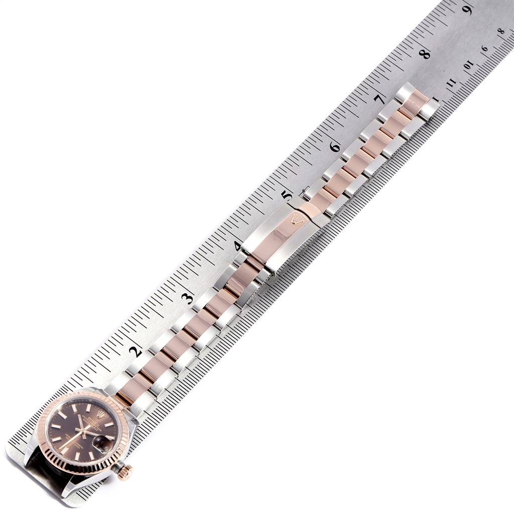 The Rolex Datejust 279171 Women's Steel and Gold (two tone) Brown Dial 279171 Women's Steel and Gold (two tone) Brown Dial watch is shown laid flat with its band measured against a ruler.