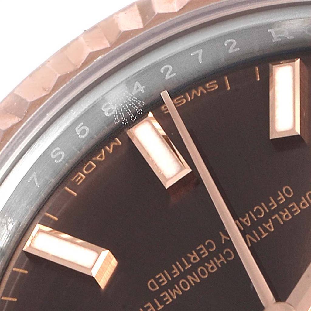 This close-up photo of a Rolex Datejust 279171 Women's Steel and Gold (two tone) Brown Dial 279171 Women's Steel and Gold (two tone) Brown Dial watch showcases a portion of the dial and the fluted bezel.
