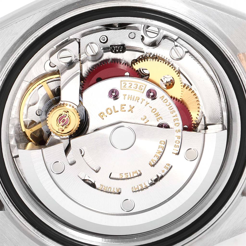 This is a close-up view of the Rolex Datejust 279171 Women's Steel and Gold (two tone) Brown Dial 279171 Women's Steel and Gold (two tone) Brown Dial watch movement showing intricate gears and the "Rolex" inscription.