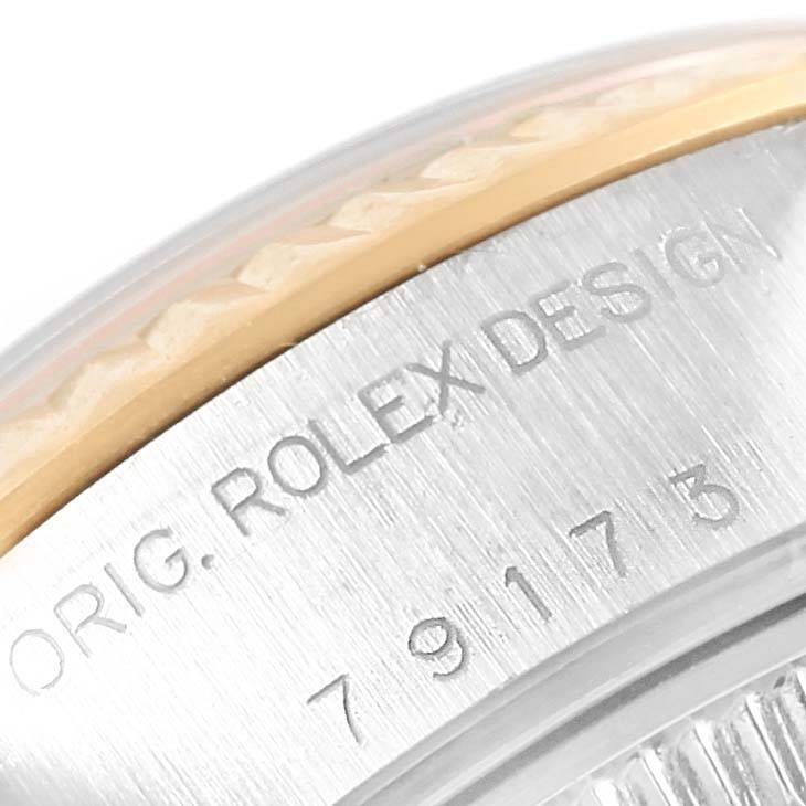 This image shows a close-up of the case side of a Rolex Datejust 79173 Women's Stainless Steel Mother of Pearl Dial 79173 Women's Stainless Steel Mother of Pearl Dial watch, featuring the Rolex design engraving.