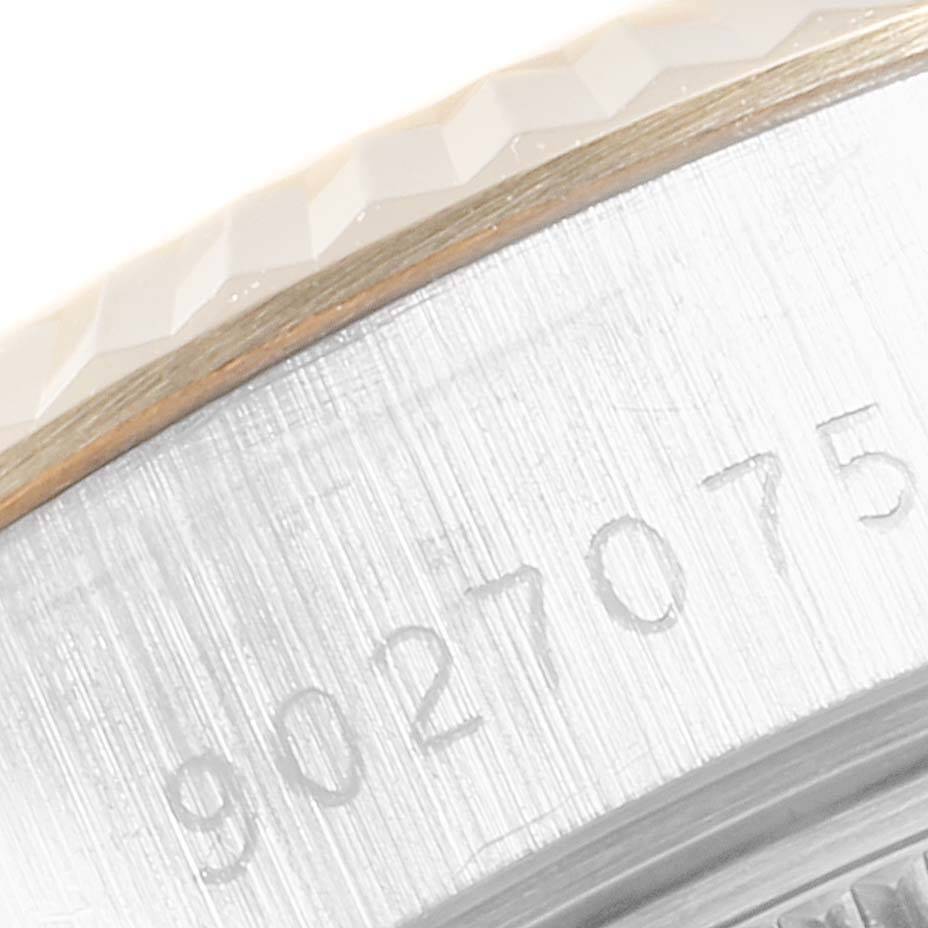 This close-up image displays the side of a Rolex Datejust 69173 Women's Stainless Steel Champagne Dial 69173 Women's Stainless Steel Champagne Dial watch, showcasing its serial number and a portion of the textured bezel.