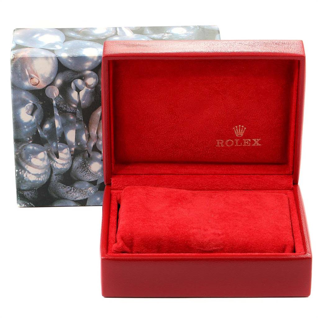 This image shows an open red Rolex Datejust 69173 Women's Stainless Steel Champagne Dial 69173 Women's Stainless Steel Champagne Dial watch box with a cushioned interior and a decorative outer box behind it.