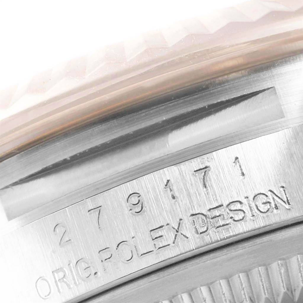 This close-up image shows the serial number and "ORIG. ROLEX DESIGN" engraved on the case of a Rolex Datejust 279171 Women
s Steel and Gold (two tone) Mother of Pearl Dial 279171 Women
s Steel and Gold (two tone) Mother of Pearl Dial watch.
