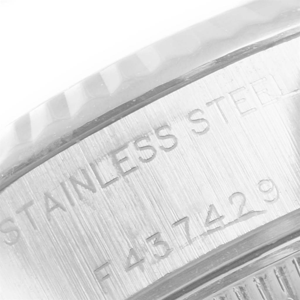 The image shows the side view of a Rolex Datejust 79174 Women's Stainless Steel White Dial 79174 Women's Stainless Steel White Dial model, focusing on the stainless steel case and its serial number engraving.
