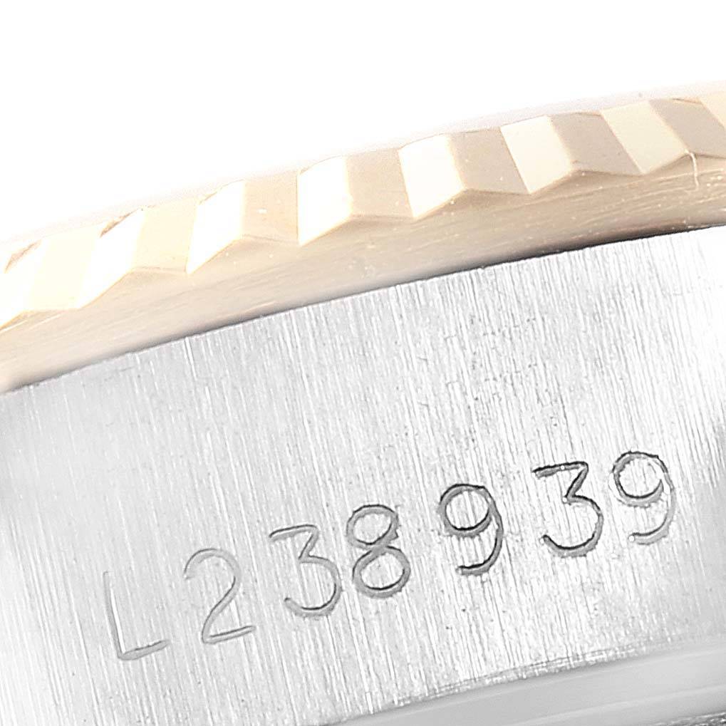 This close-up of the Rolex Datejust 69173 Women
s Stainless Steel Silver Dial 69173 Women
s Stainless Steel Silver Dial model shows a portion of the fluted bezel and serial number engraving on the case side.