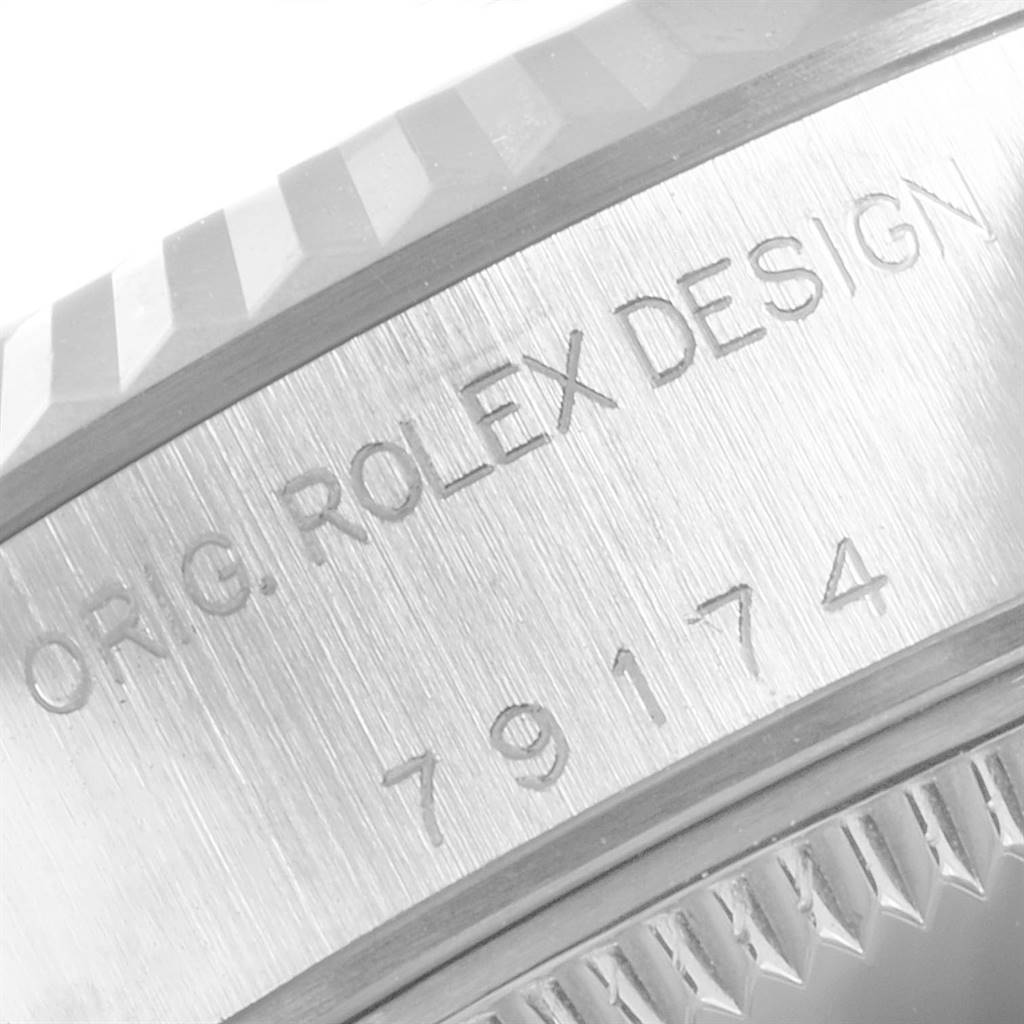 This image shows the engraved serial and model numbers on the case of a Rolex Datejust 79174 Women
s Stainless Steel Mother of Pearl Dial 79174 Women
s Stainless Steel Mother of Pearl Dial watch.