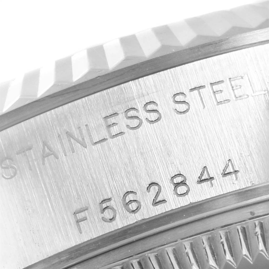 The image shows a close-up of the engraved stainless steel case and fluted bezel of a Rolex Datejust 79174 Women
s Stainless Steel Mother of Pearl Dial 79174 Women
s Stainless Steel Mother of Pearl Dial watch.