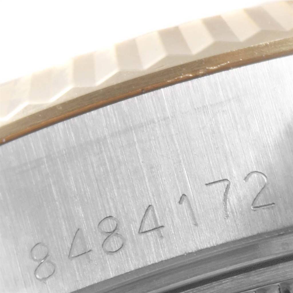 This close-up image of a Rolex Datejust 69173 Women's Stainless Steel Champagne Dial 69173 Women's Stainless Steel Champagne Dial watch shows the serial number engraved on its fluted bezel.