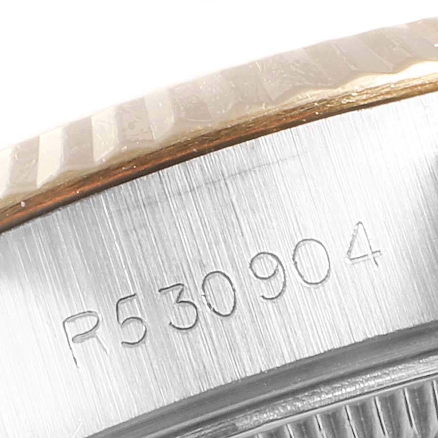 This image captures a close-up of the serial number engraved on the side of a Rolex Datejust 69173 Women
s Stainless Steel Black Dial 69173 Women
s Stainless Steel Black Dial watch, along with the edge of the bezel.