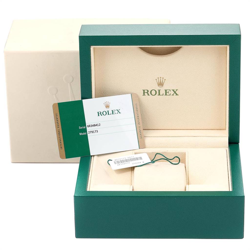 This image shows the open packaging of a Rolex Datejust 279173 Women's Steel and Gold (two tone) Purple Dial 279173 Women's Steel and Gold (two tone) Purple Dial watch, including the inner box, cushion, tag, and warranty card.