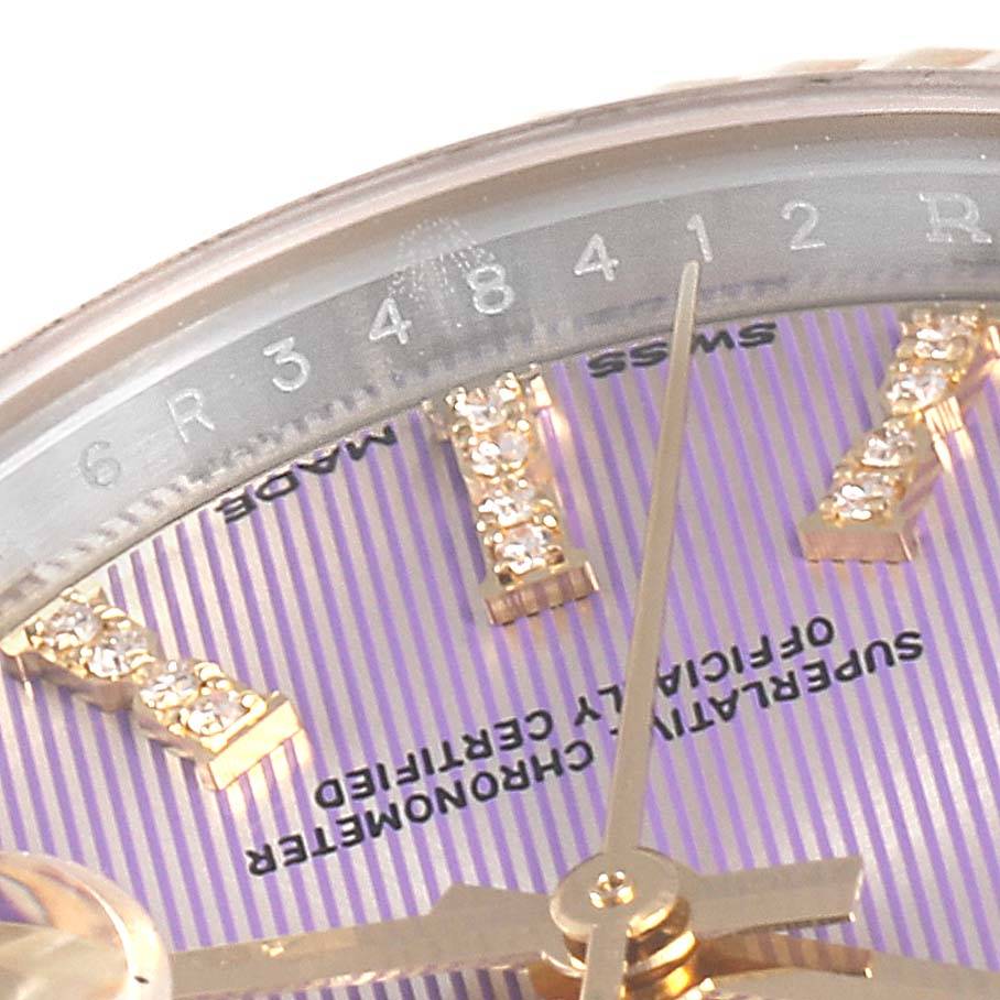 Close-up image of a Rolex Datejust 279173 Women's Steel and Gold (two tone) Purple Dial 279173 Women's Steel and Gold (two tone) Purple Dial watch dial, showing the hands, part of the bezel, and diamond hour markers.