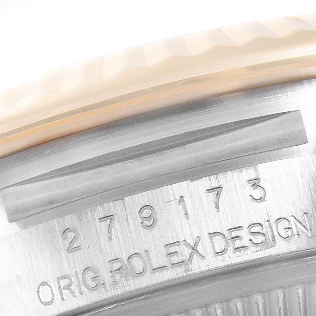 This close-up image shows the serial numbers and "ORIG ROLEX DESIGN" inscription on the side of the Rolex Datejust 279173 Women's Steel and Gold (two tone) Purple Dial 279173 Women's Steel and Gold (two tone) Purple Dial watch case.