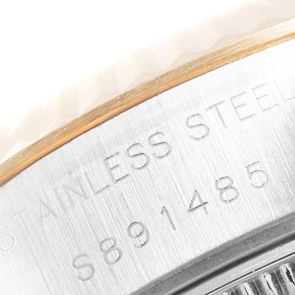 The image shows an angled close-up of the side engraving and bezel of a Rolex Datejust 69173 Women's Stainless Steel Champagne Dial 69173 Women's Stainless Steel Champagne Dial watch.