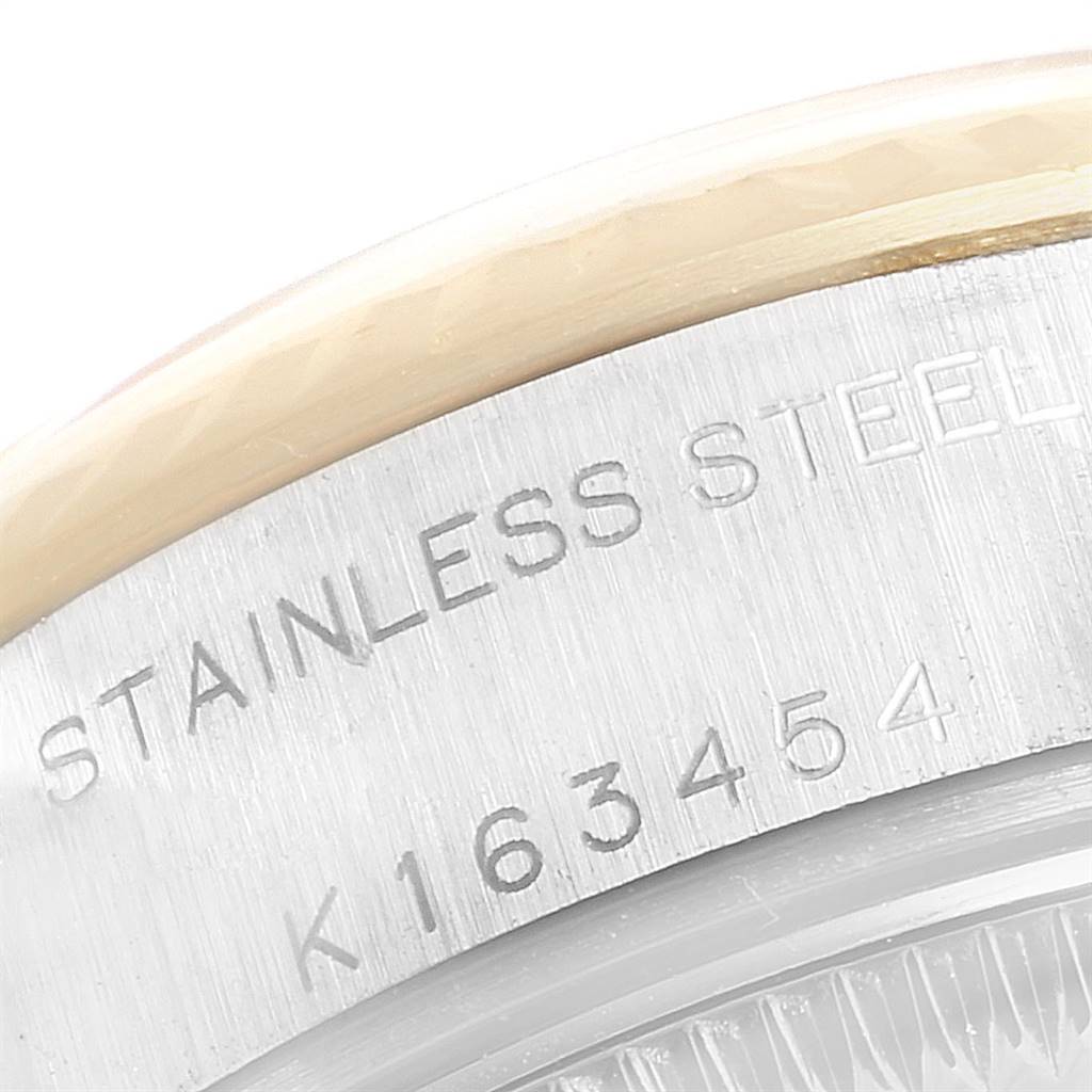 The image shows a close-up of the case back engraving of a Rolex Datejust 79173 Women
s Stainless Steel Blue Dial 79173 Women
s Stainless Steel Blue Dial watch, highlighting the serial number and material.